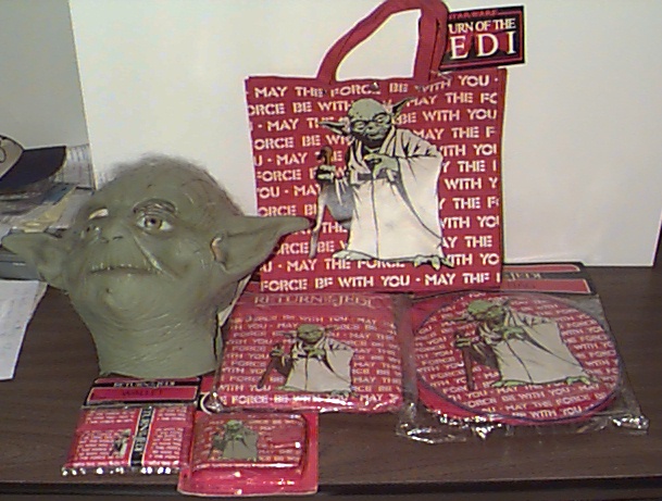 2 Yoda wallets, the Don Post mask, a duffel bag, a backpack, and a barrel bag