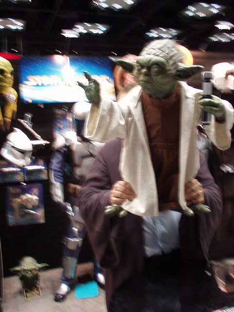 Rubies employee lifting Yoda replica at Celebration 2