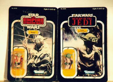 2 different variations of the old Yoda toys still in the packages