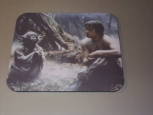 A mousepad with Luke and Yoda on it