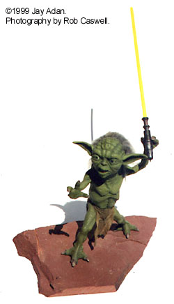 Yoda stature by Gray Zon with a yellow lightsaber