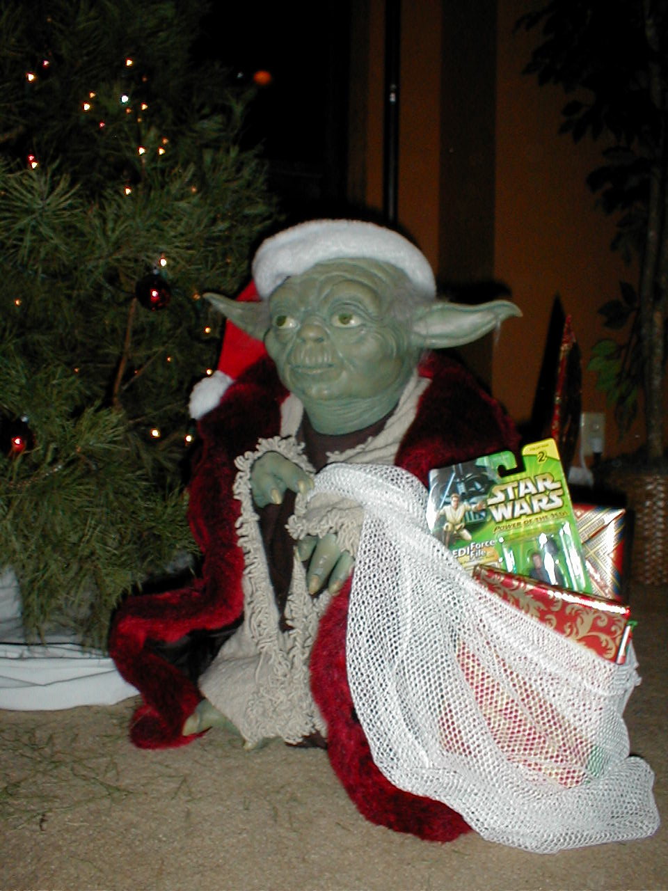 Lifesize Santa Yoda replica with a bag full of gifts