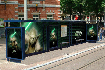 A bus shelter with Revenge of the Sith Yoda advertisements