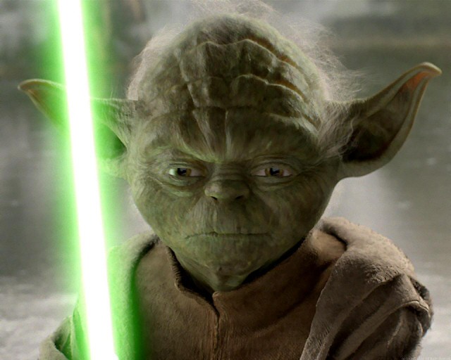 Yoda with his lightsaber, ready for battle