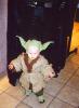 A baby dressed up in a Yoda costume - 329x450